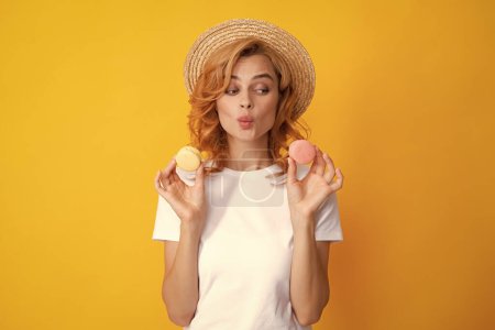 Photo for Charming woman want to bite tasty macaron, holding macaroon near open mouth, beauty girl enjoying sweets - Royalty Free Image