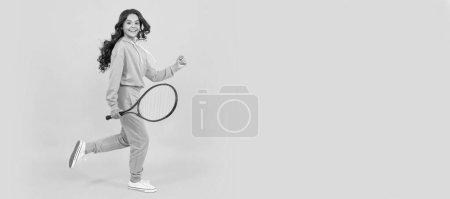 Téléchargez les photos : Happy energetic kid jump in sportswear with tennis racket running to success, active childhood. Horizontal poster of isolated child face, banner header, copy space - en image libre de droit