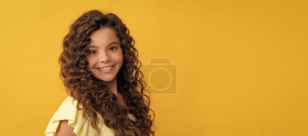 Photo for Happy kid with long curly hair and perfect skin, beauty. Child face, horizontal poster, teenager girl isolated portrait, banner with copy space - Royalty Free Image