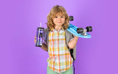 Photo for Stylish little child with skateboard and water bottle over isolated background - Royalty Free Image
