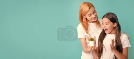 Photo for Mother and daughter child banner, copy space, isolated background. Nurture and cherish. Surprised kid look at houseplant held by mother. Foster and nurture - Royalty Free Image