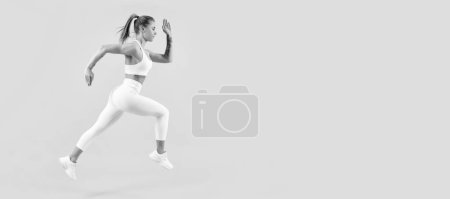 energetic fitness woman runner running on yellow background. Woman jumping running banner with mock up copyspace