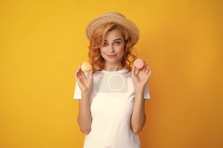 portrait of stylish beautiful pretty cute she her girl with sweets cookies macaroon isolated on yellow background