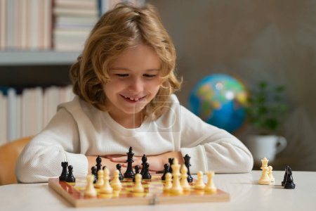 Child playing chess. Clever kid thinking about chess