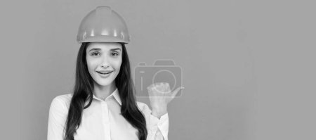 Woman isolated face portrait, banner with mock up copy space. cheerful woman worker directing thumb up. quality inspector. female construction worker