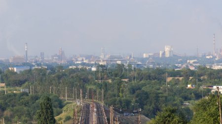 Photo for View of the industrial city of Zaporozhye, Ukraine. Smog emissions, air pollution. Bad environmental situation. Metallurgical plants. - Royalty Free Image