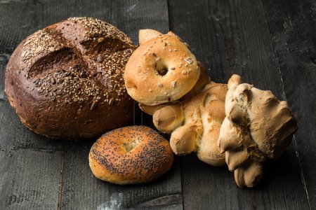 Photo for Various types of characteristic and typical bread, isolated on a wooden table - Royalty Free Image