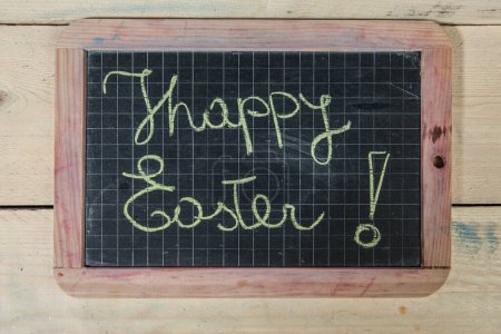 Photo for 'Happy Easter' writing on chalkboard - Royalty Free Image