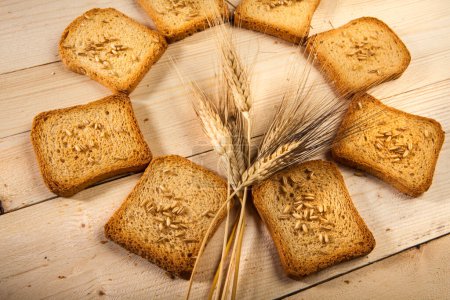 Photo for Rusks, wheat and ears on a table - Royalty Free Image