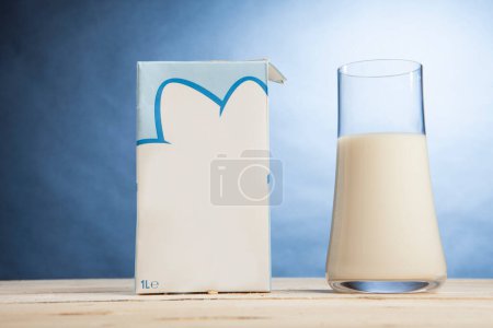 Téléchargez les photos : Carafe de lait sur table en bois sur fond non teint - en image libre de droit