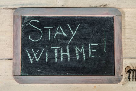 Photo for 'Stay with me' message on a wooden board - Royalty Free Image