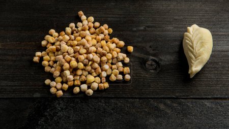 Photo for Loose Fregola and Cullurgionis, isolated on a dark wooden table - Royalty Free Image