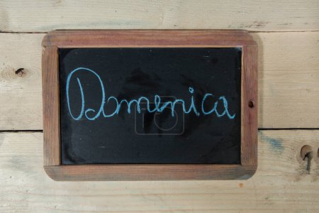 Photo for Blackboard with 'sunday' lettering on wooden background - Royalty Free Image