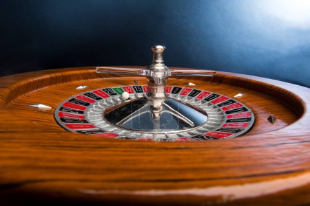 Photo for Wooden roulette isolated on blue background - Royalty Free Image