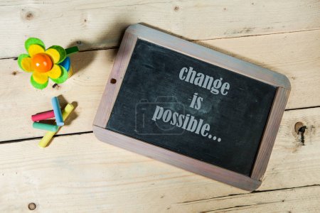 Photo for Chalkboard with the words "change is possible" - Royalty Free Image