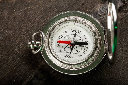 Photo for Ancient metal compass on a dark brown background - Royalty Free Image