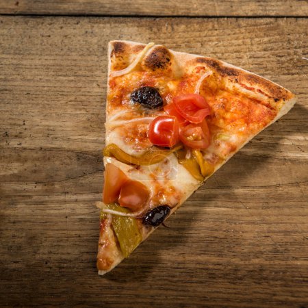 Photo for Pizza slice isolated on wooden table - Royalty Free Image