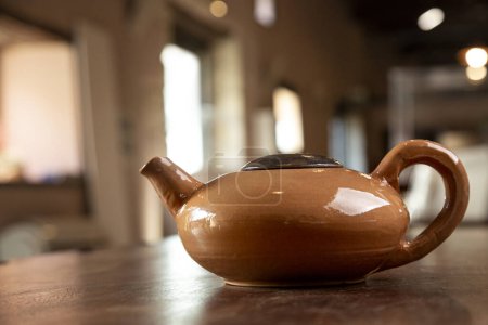 Photo for Beautiful terracotta water jug, isolated on a table inside a house - Royalty Free Image