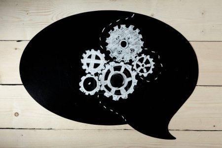 Photo for Black chalkboard on wooden background with the drawing of a mechanism - Royalty Free Image