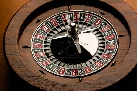 Photo for Wooden roulette isolated on wood background - Royalty Free Image