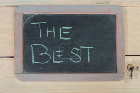 Photo for 'best' on blackboard with chalk on wooden background - Royalty Free Image