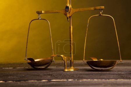 Photo for Ancient scale on wooden table with dark background - Royalty Free Image