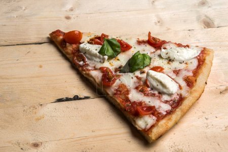 Photo for Detail of a Pizza with tomatoes, mozzarella and basil - Royalty Free Image