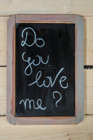 Photo for 'Do you love me?' on a blackboard - Royalty Free Image