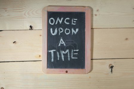 Photo for Black chalkboard on wooden background with the inscription: "once upon a time" - Royalty Free Image