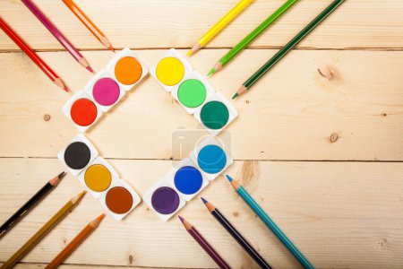Photo for Colorful pencils and paints on wooden background. art concept - Royalty Free Image