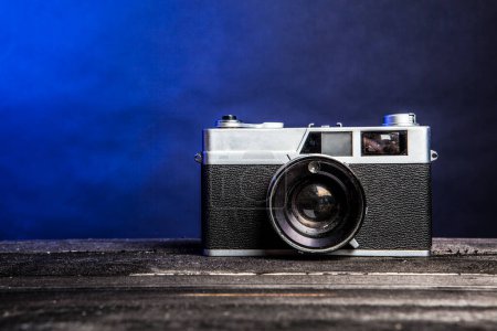 Photo for Old camera on wooden table - Royalty Free Image