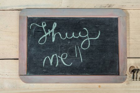 Photo for School blackboard on wooden table with "I miss you" written on it - Royalty Free Image