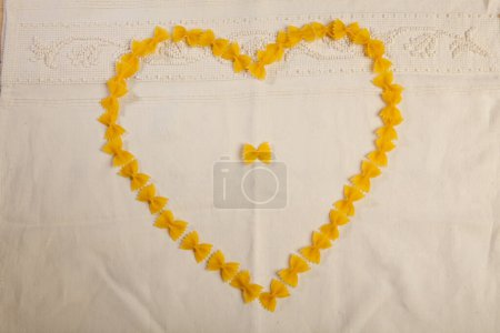 Photo for Heart formed by short pasta on a white background - Royalty Free Image