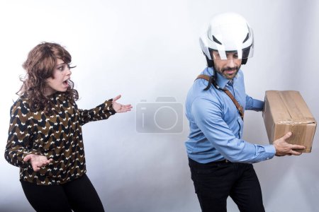 Photo for Courier with helmet does not want to make a delivery to a lady who gets angry, isolated on white background - Royalty Free Image