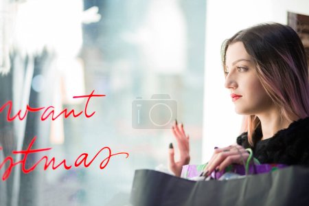 Photo for Beautiful woman with brown hair painted in purple around the shops to go shopping - Royalty Free Image