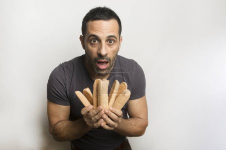 Photo for Man with ladyfingers in hand on white background - Royalty Free Image