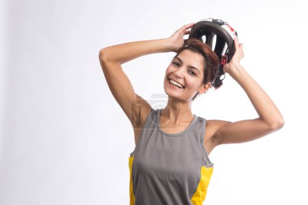 Photo for Woman cyclist in the technical helmet, isolated on light background - Royalty Free Image