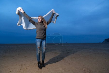 Foto de Hermosa chica rubia con bufanda cerca de la costa - Imagen libre de derechos