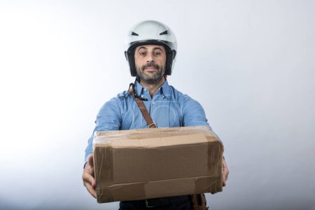 Photo for Delivery man in helmet isolated on gray background - Royalty Free Image
