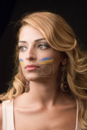 Photo for Portrait of beautiful young woman with Ukrainian flag painted on face on grey background - Royalty Free Image