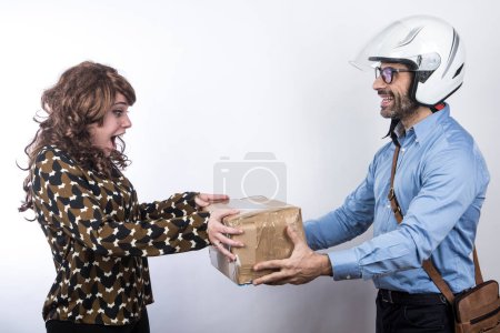 Photo for Courier with helmet makes delivery of a parcel to an incredulous lady, isolated on white background - Royalty Free Image
