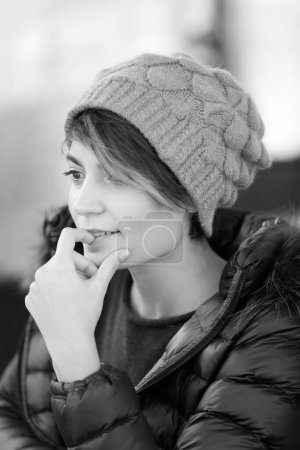 Photo for Portrait of beautiful smiling girl with cap and coat, black and white - Royalty Free Image