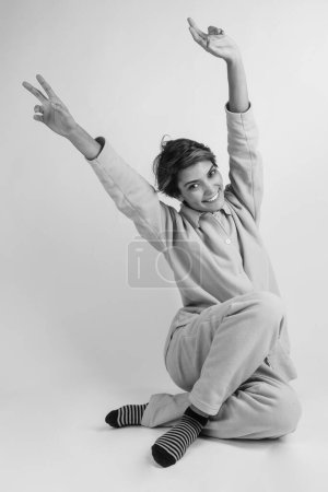 Photo for Girl in pajamas and happy on her awakening, isolated on white background, black and white - Royalty Free Image