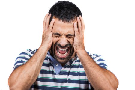 Photo for Dark-haired man with black hair and striped polo shirt puts his hands to his head as a sign of headache - Royalty Free Image