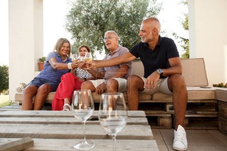 Photo for Happy senior people drinking wine on terrace - Royalty Free Image