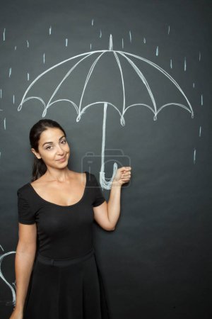 Téléchargez les photos : Belle fille tient un parapluie dessiné sur un tableau - en image libre de droit