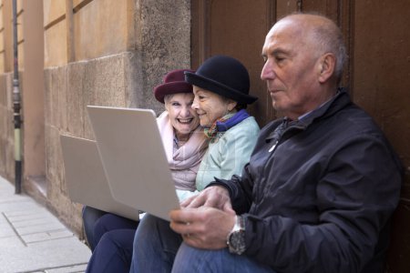 Photo for Senior people using laptops outdoors - Royalty Free Image