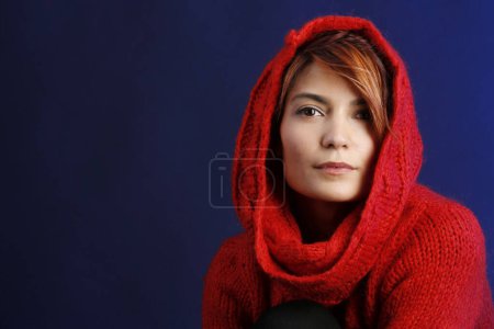 Photo for Beautiful girl with red sweater bob hair isolated on blue background - Royalty Free Image