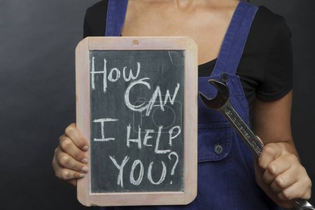 Photo for Woman holding chalkboard with text "How can I help you?" - Royalty Free Image