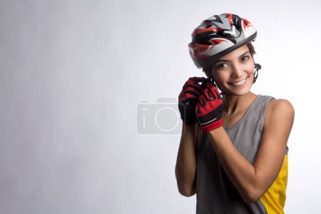 Photo for Woman cyclist in the technical helmet, isolated on light background - Royalty Free Image